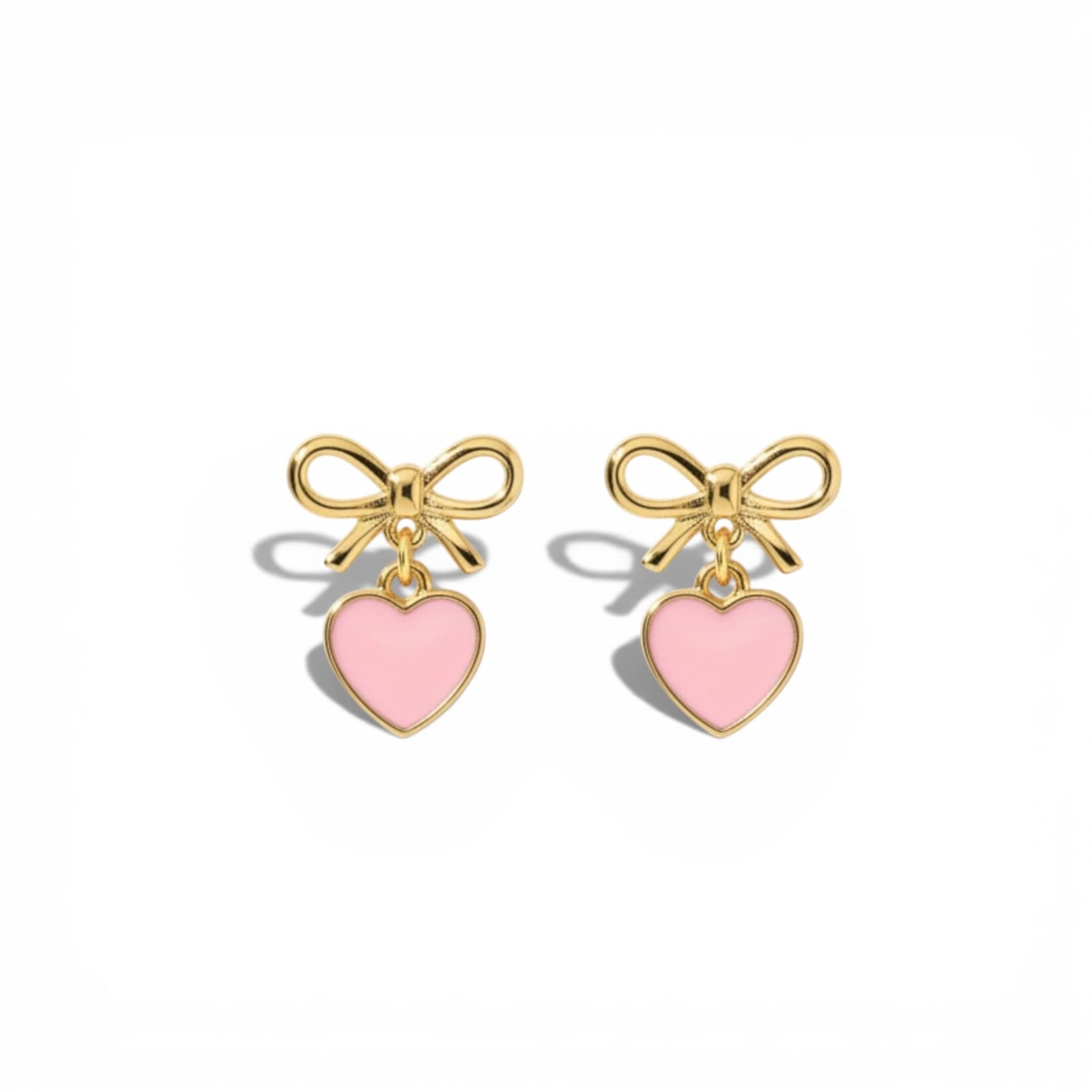 Gold Dabble Doll heart earrings with pink enamel hearts and delicate bow details