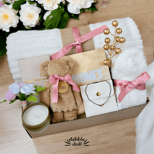 Dabble Doll hygge gift box for women with cozy towel bear candle and floral accents