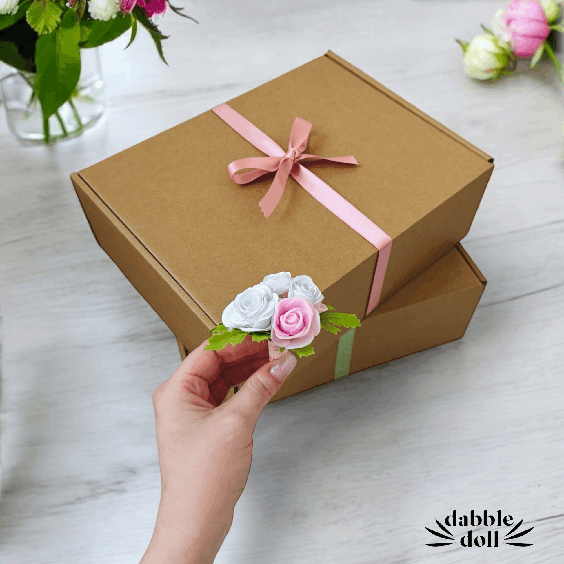 Hygge gift box for women with brown packaging and pink ribbon by Dabble Doll