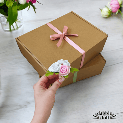Hygge gift box for women with brown packaging and pink ribbon by Dabble Doll