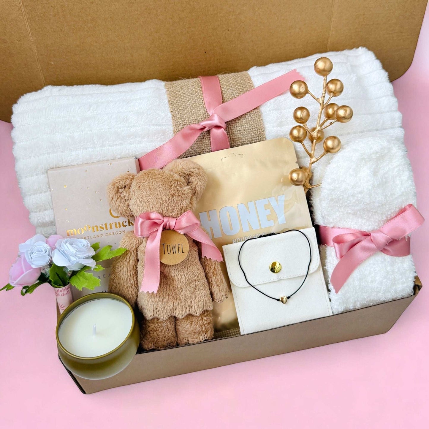 Dabble Doll hygge gift box for women with cozy towel, teddy bear, candle, flowers, and jewelry