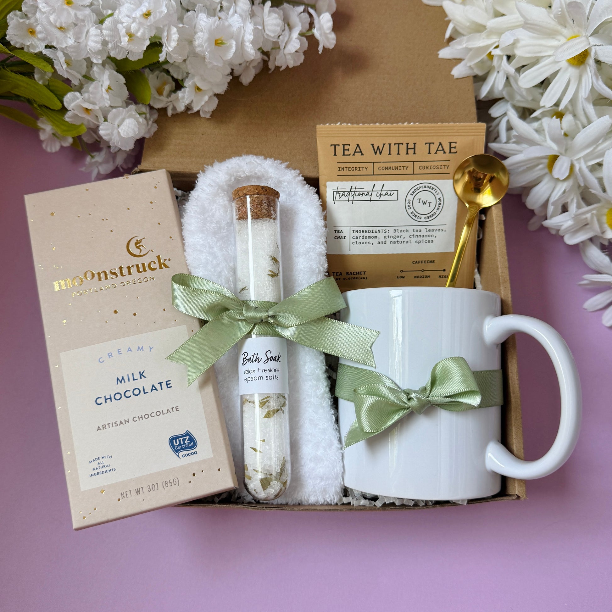 Dabble Doll gift in box featuring milk chocolate, a mug, tea, and a decorative spoon