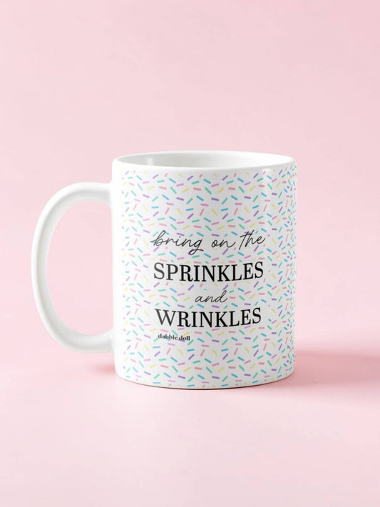 Dabble Doll mug featuring the phrase Bring on the Sprinkles and Wrinkles with colorful sprinkle design