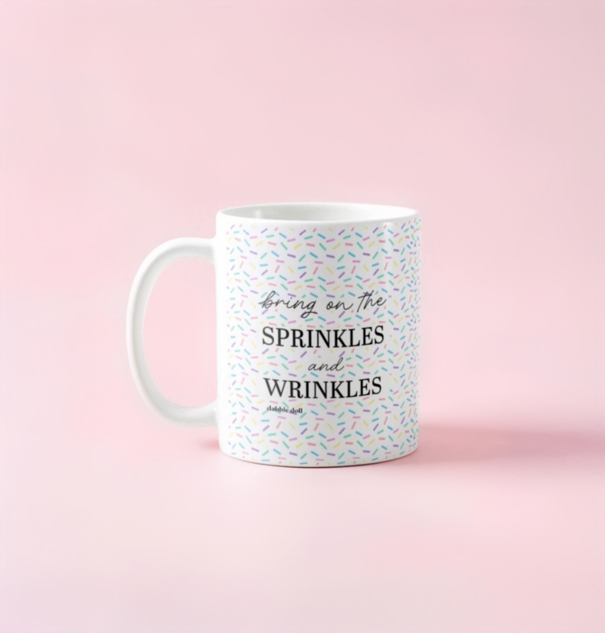 Dabble Doll coffee mug with colorful sprinkles design and the text Bring on the Sprinkles and Wrinkles