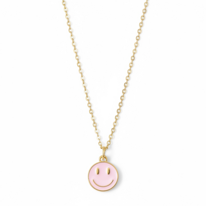 Dabble Doll necklace smiley face in gold with a pink enamel charm for cheerful style