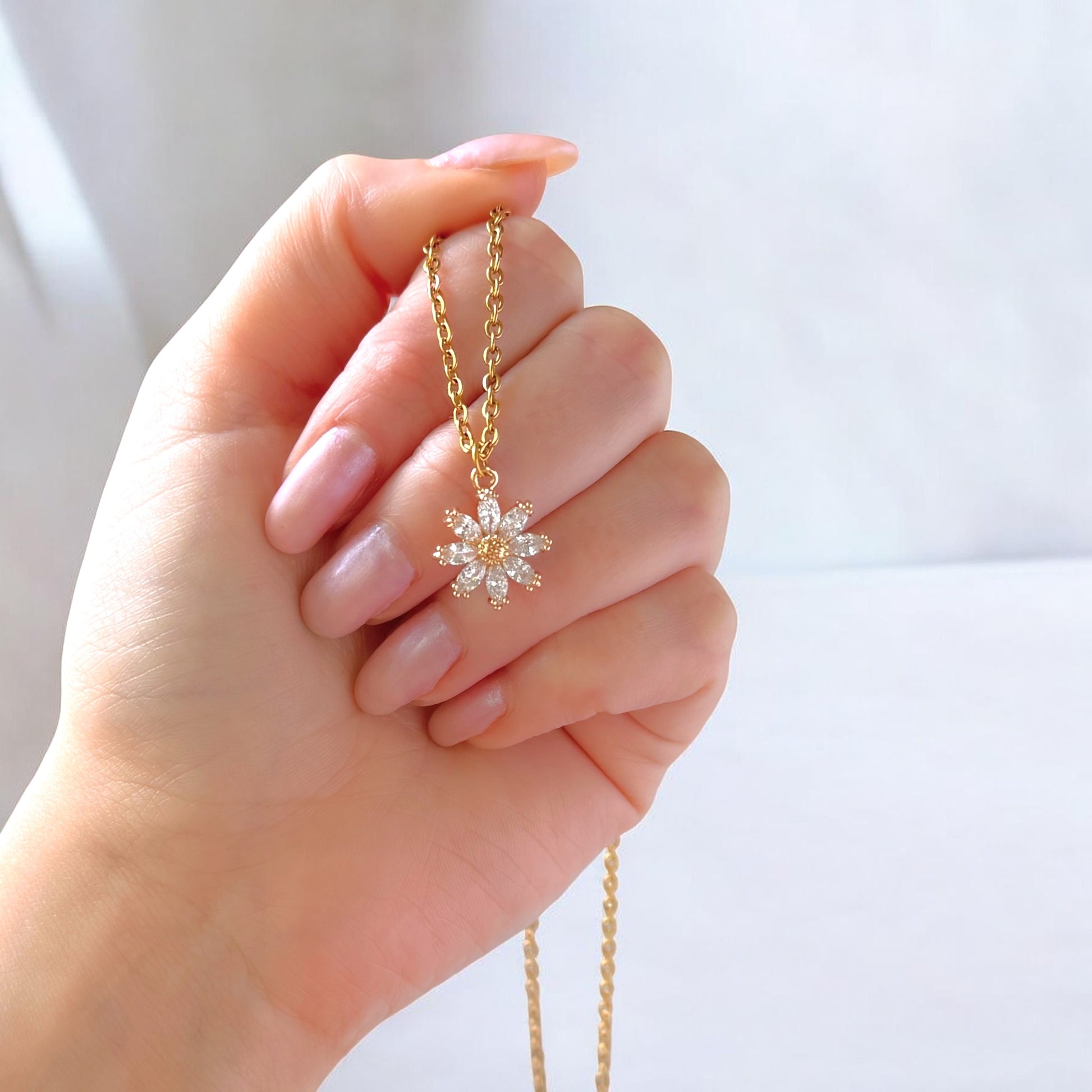 Dabble Doll Gift Box featuring a delicate necklace with star design, presented elegantly in hand