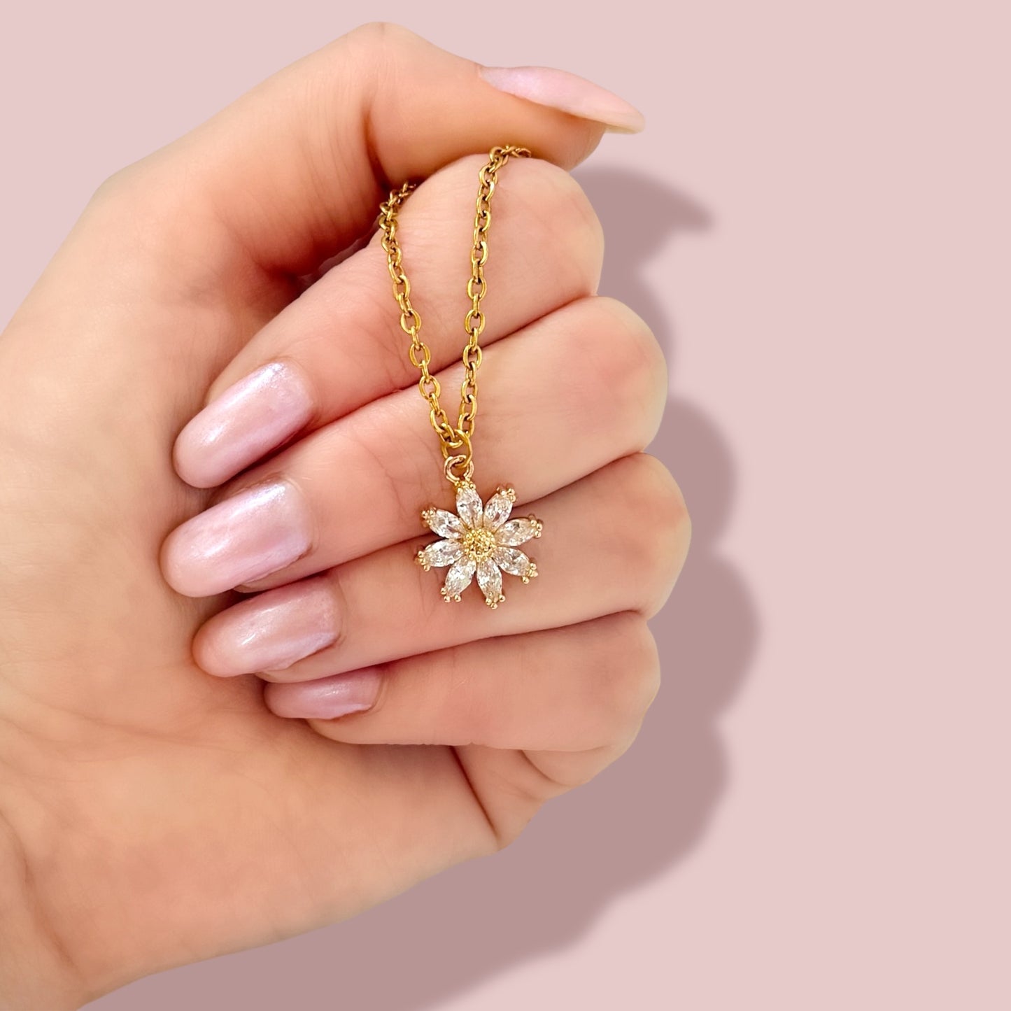 Gold necklace with star pendant held in a hand, perfect for gifting and special occasions