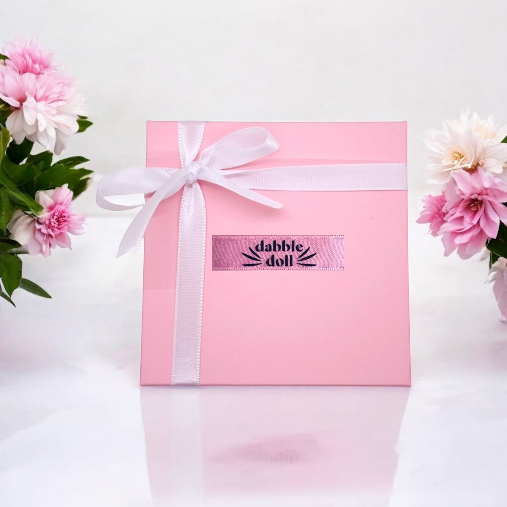 Dabble Doll pink gift box with ribbon for presenting a necklace with star inside