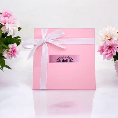 Dabble Doll pink gift box with ribbon for presenting a necklace with star inside