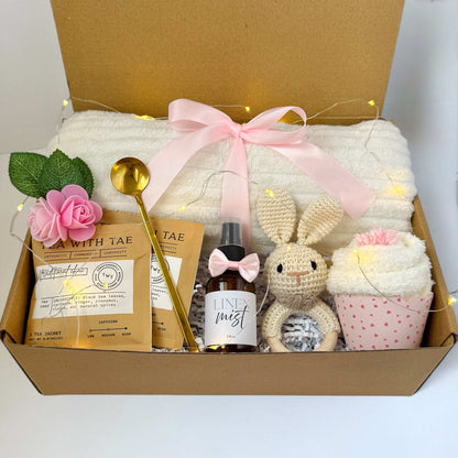 Dabble Doll new mom gift box with cozy blanket, linen mist, tea packets, crocheted bunny, and cupcake towel