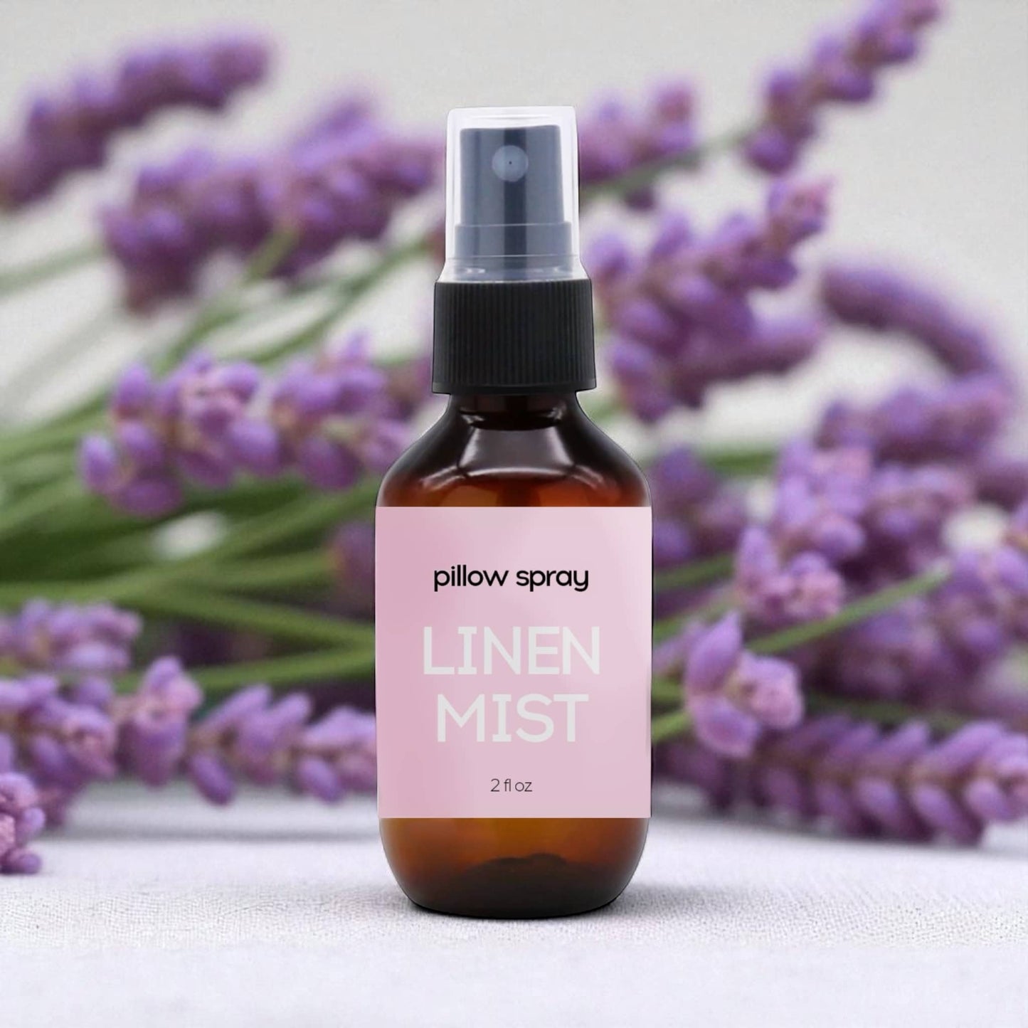 Dabble Doll Linen Mist Pillow Spray in amber bottle with floral lavender background for women and girls