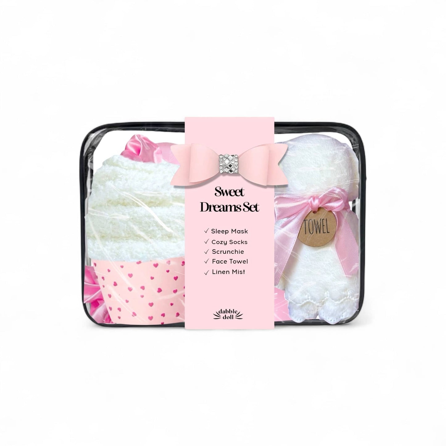 Dabble Doll sleep gift set in pink featuring a sleep mask, cozy socks, scrunchie, and linen mist for women