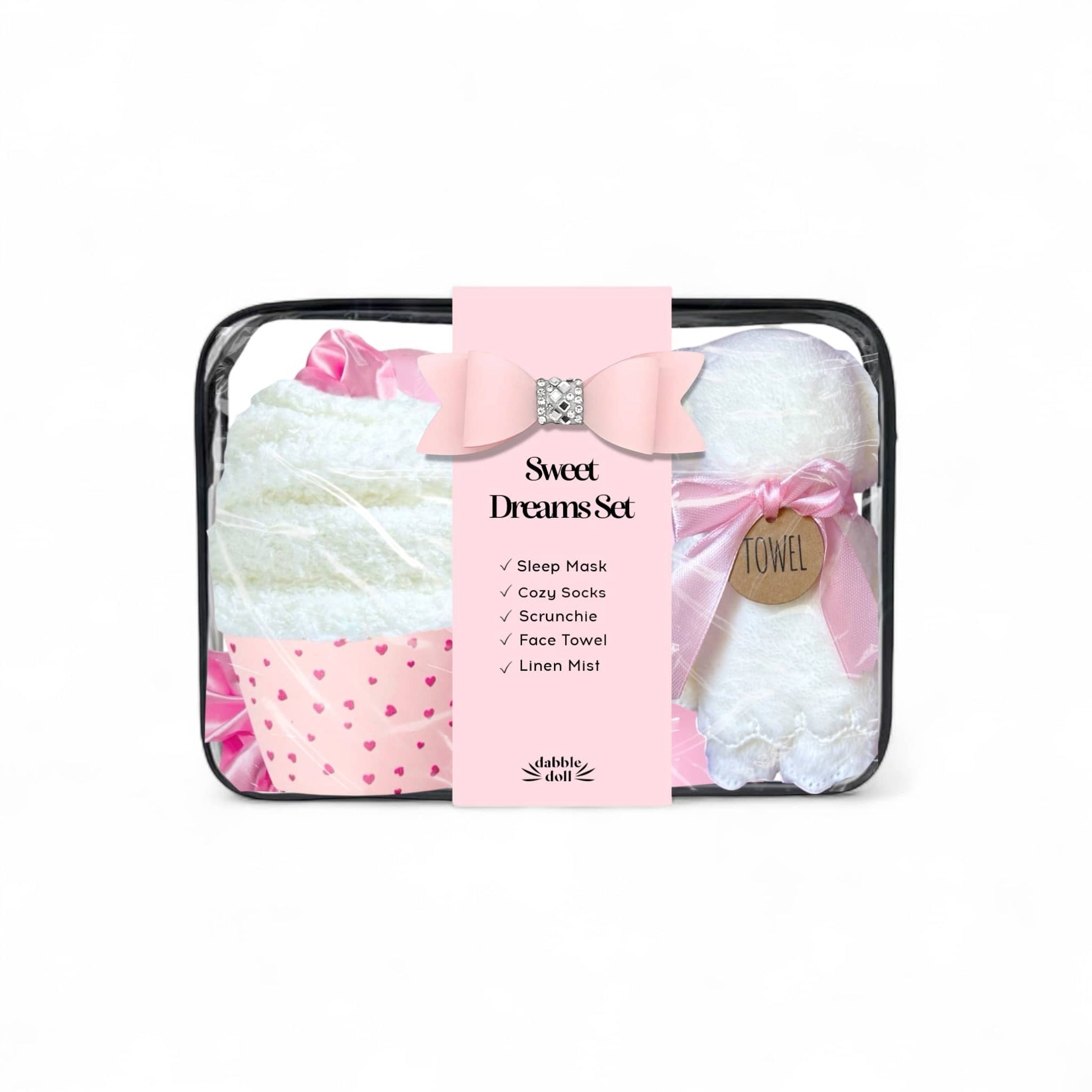 Dabble Doll sleep gift set in pink featuring a sleep mask, cozy socks, scrunchie, and linen mist for women