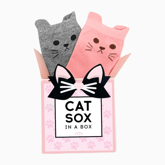Dabble Doll Cat Sox in a Box featuring two pairs of cute cat-themed socks in pink and gray