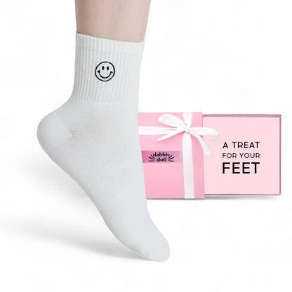 Dabble Doll White Socks featuring a smiley face design, perfect for cozy comfort