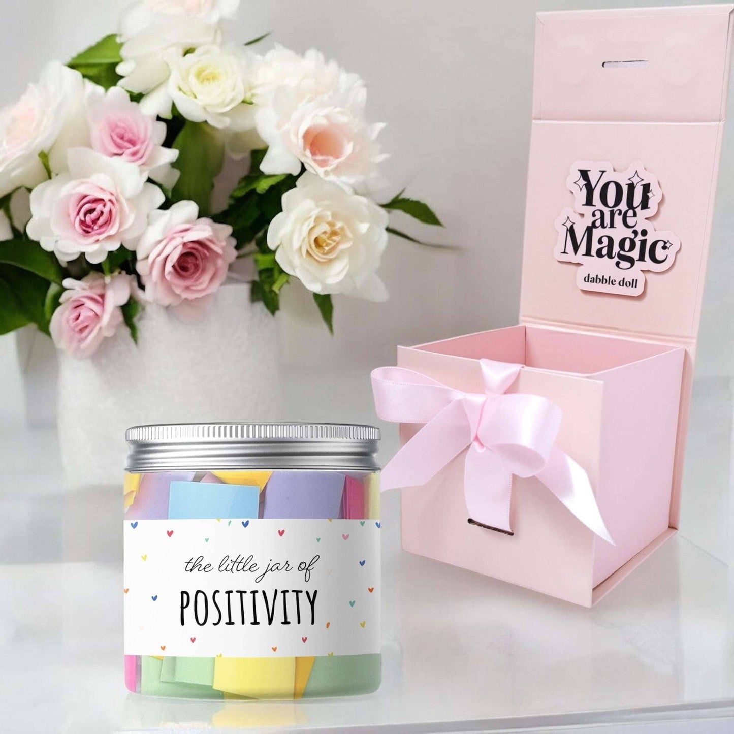 Dabble Doll pink gift box with a jar of positivity notes, perfect for girls and women, featuring colorful paper strips