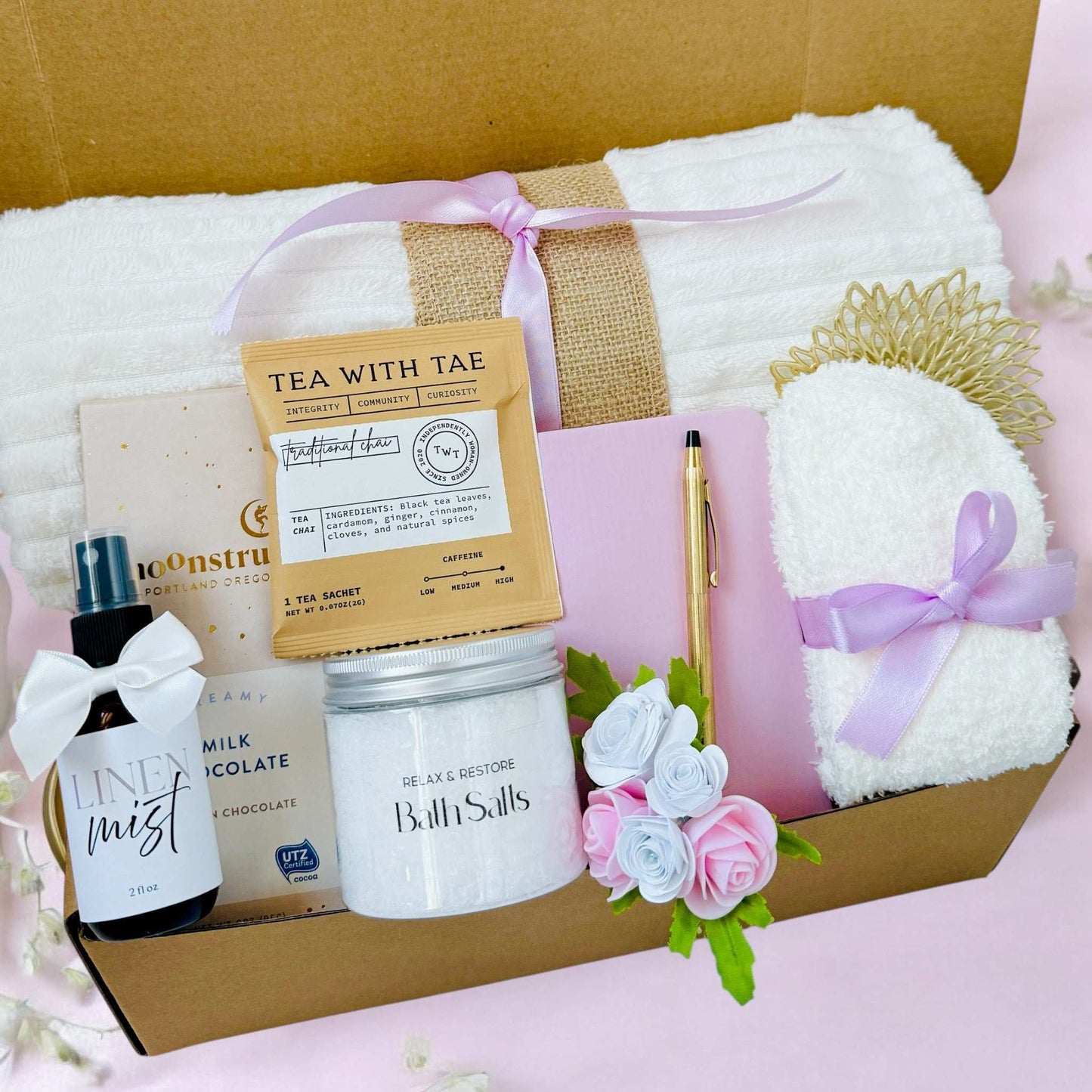 Dabble Doll thoughtful hygge gift basket with towel, bath salts, tea, linen mist, chocolate, and cozy socks