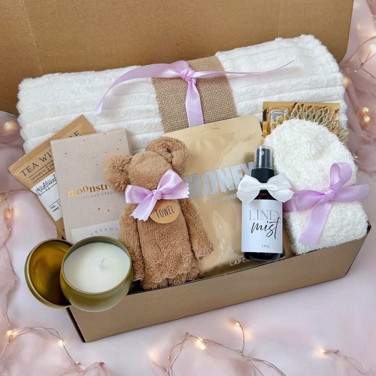 Dabble Doll thoughtful hygge gift basket with cozy towel, candle, honey packet, linen mist, and skincare items