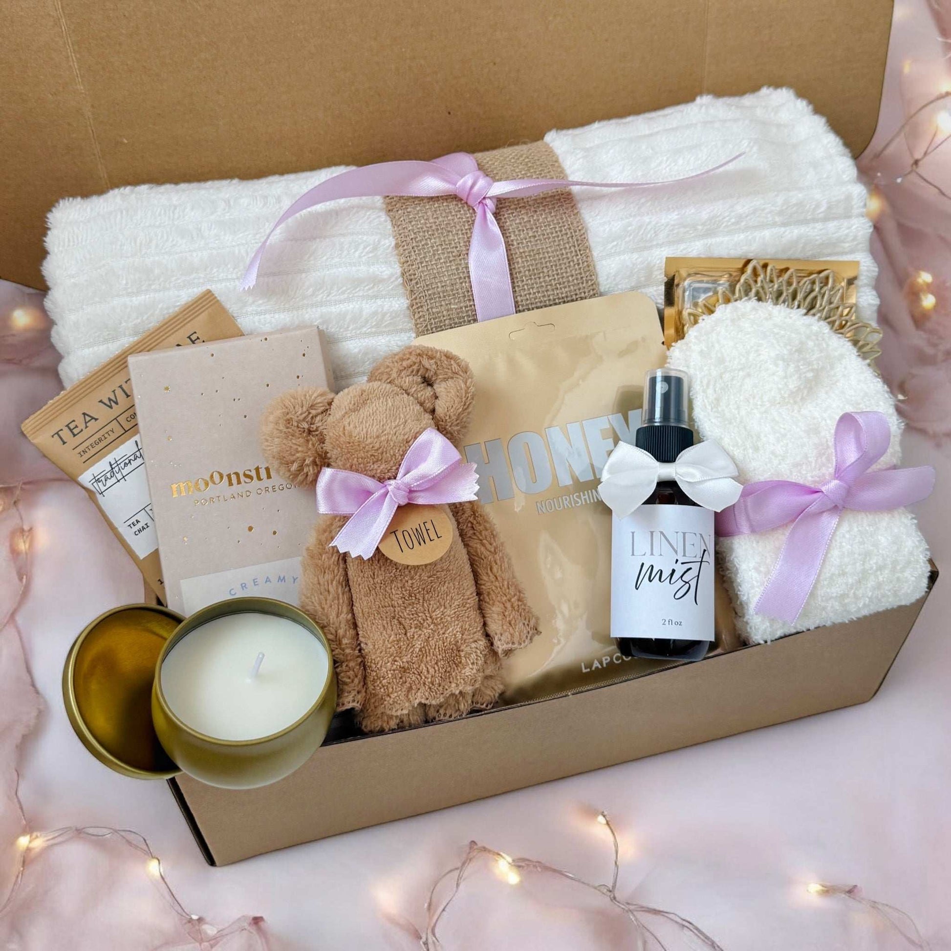 Dabble Doll thoughtful hygge gift basket with cozy towel, candle, honey packet, linen mist, and skincare items