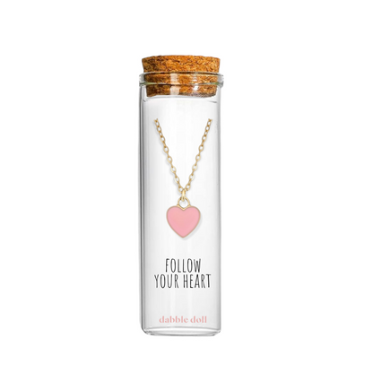 Dabble Doll Tiffanys necklace heart in pink, displayed in a glass bottle with a cork lid.