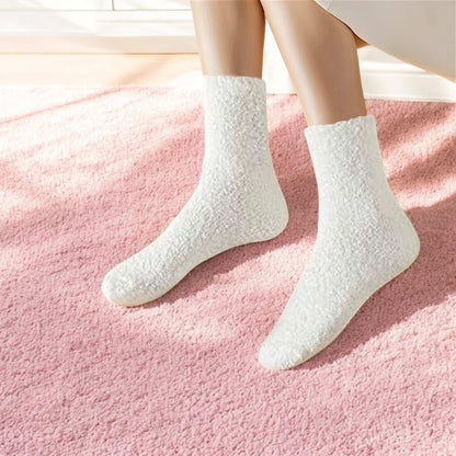White cozy socks worn on feet on a pink carpet showcasing unique comfort socks present by Dabble Doll