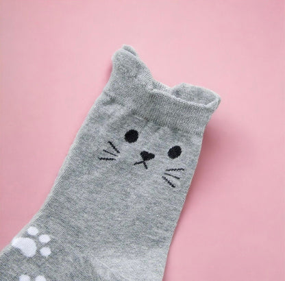 Dabble Doll cute gray cat socks with whiskers and paw prints on a pink background