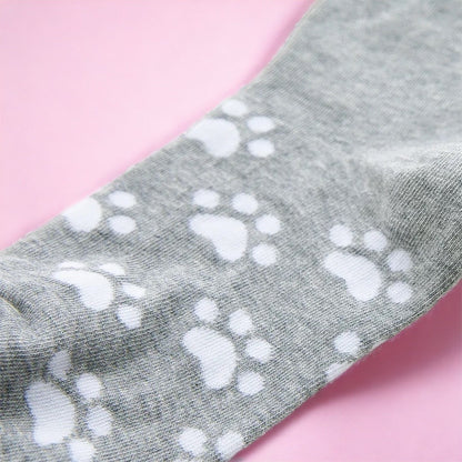 Dabble Doll cute gray cat socks with white paw prints on a soft gray fabric background